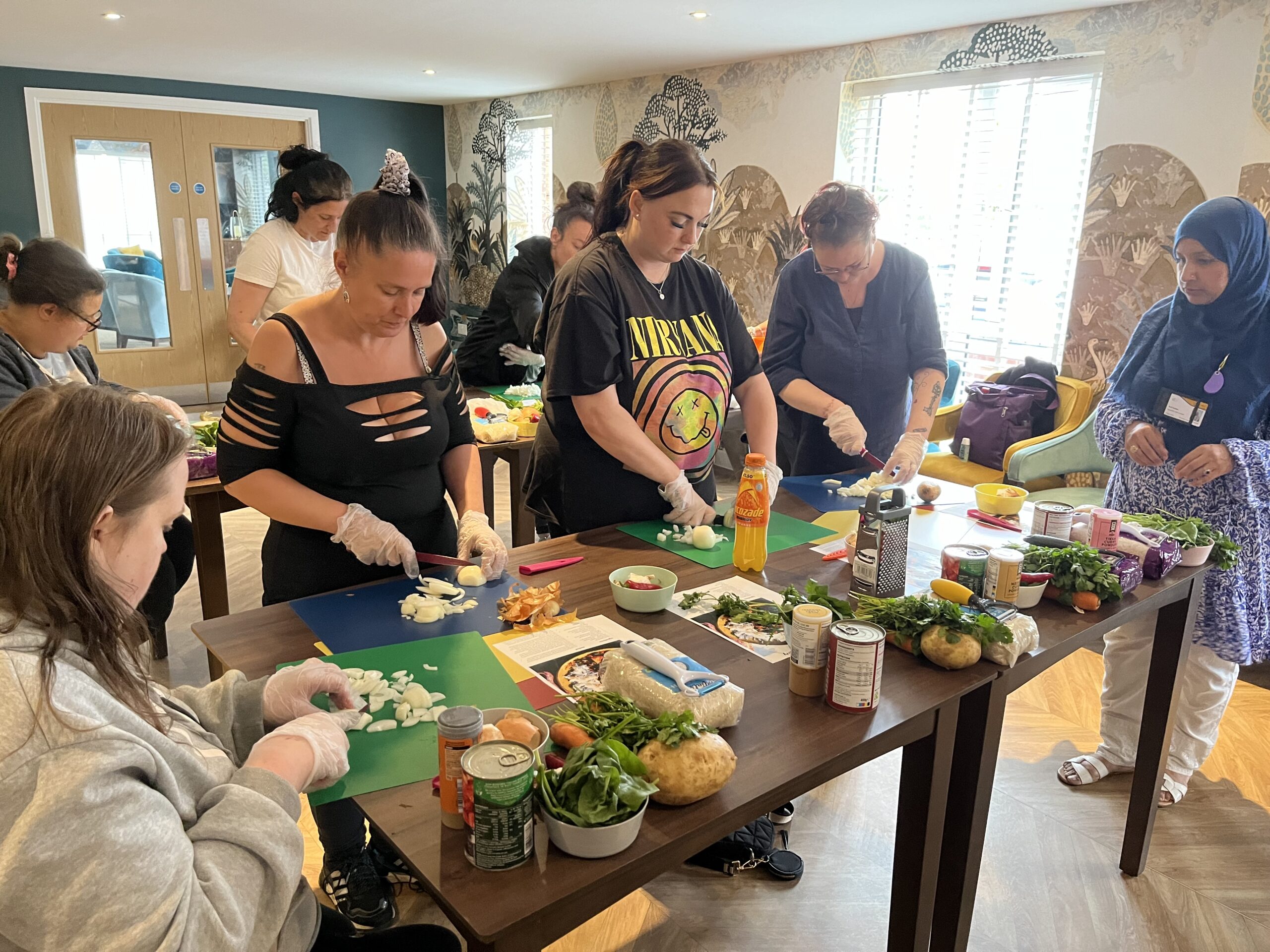 Photo of people chopping up ingredients in cooking class