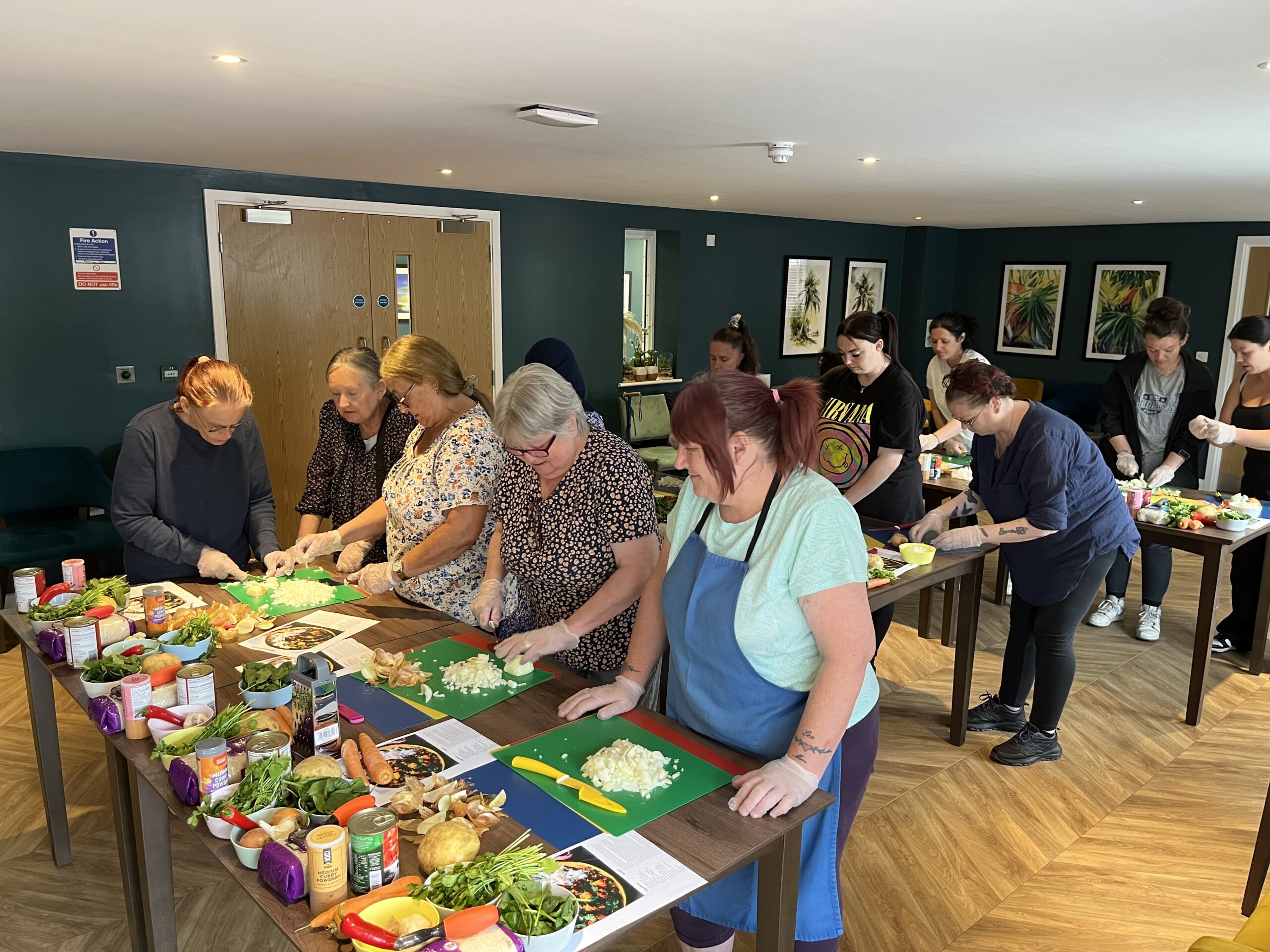 Photo of people chopping up ingredients in cooking class